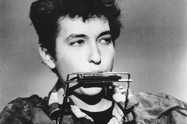 Folk singer and songwriter Bob Dylan plays the harmonica and acoustic guitar in March 1963 at an unknown location. He was born in Duluth, Minnesota in 1941 as Robert Allen Zimmerman. (AP Photo)